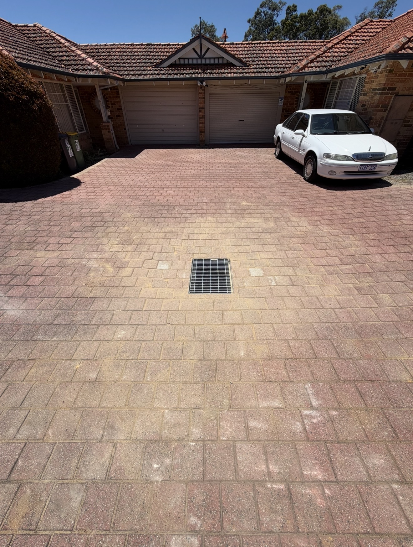 Finished soakwell lid replacement on a Perth driveway — new galvanised grate installed flush into the pavers