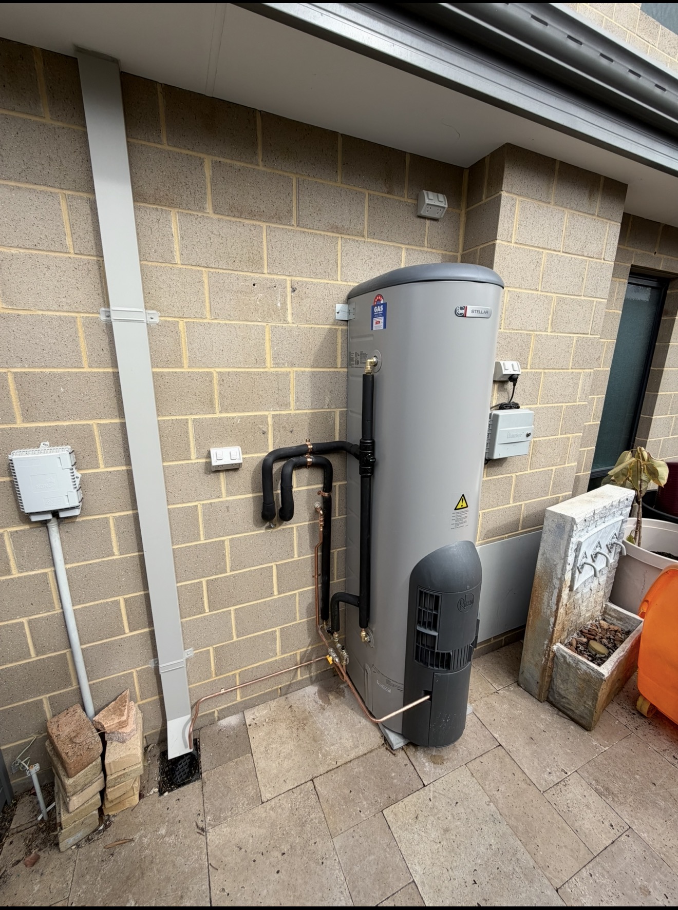 Rheem Stellar gas storage hot water system installed on a Perth patio with clean copper pipework